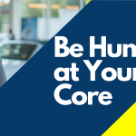 Former CEO of Cox Automotive Sandy Schwartz, in a blue button down and gray suit jacket, standing behind an info graphic saying "Be Human at Your Core."